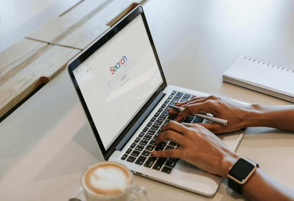 Small business owner searching Google on laptop to learn SEO basics